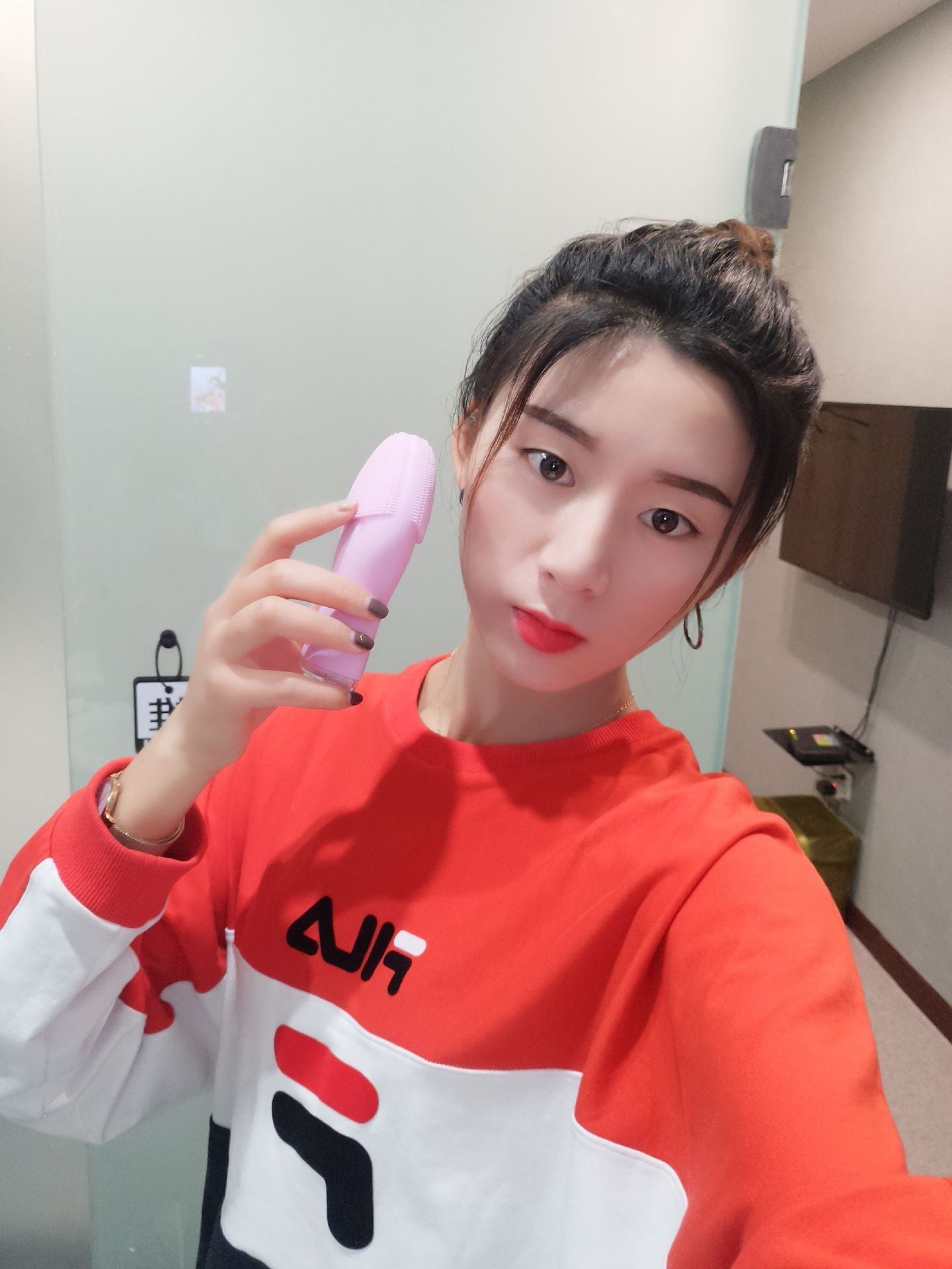 Hand holding waterproof silicone face scrubber